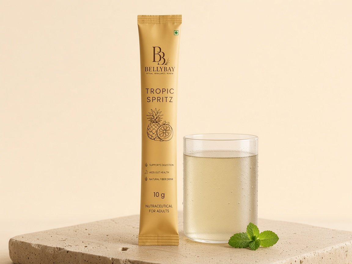BellyBay Tropic Spritz sachet beside a glass of water